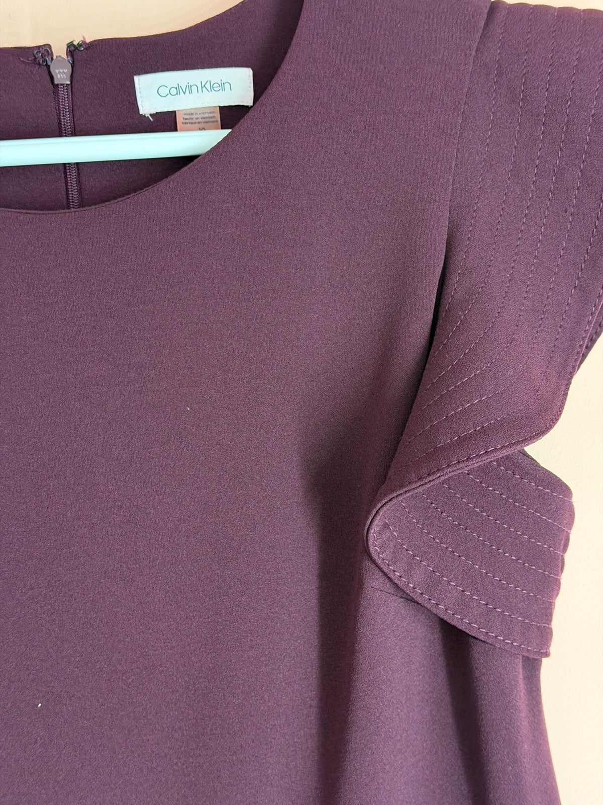 Calvin Klein tag, size 10, with ruffle sleeve detail