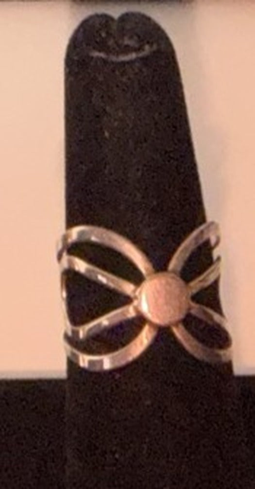 Sterling silver openwork bow ring with a round center bead on a black display cone, size 7