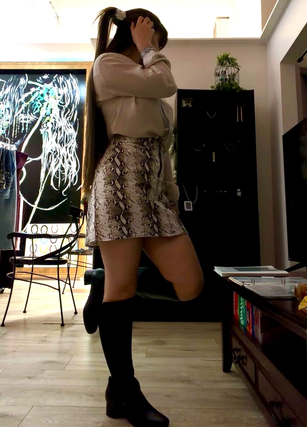 Cream long-sleeve blouse with lace cuffs worn with a python print skirt in store at Regul Design Studio