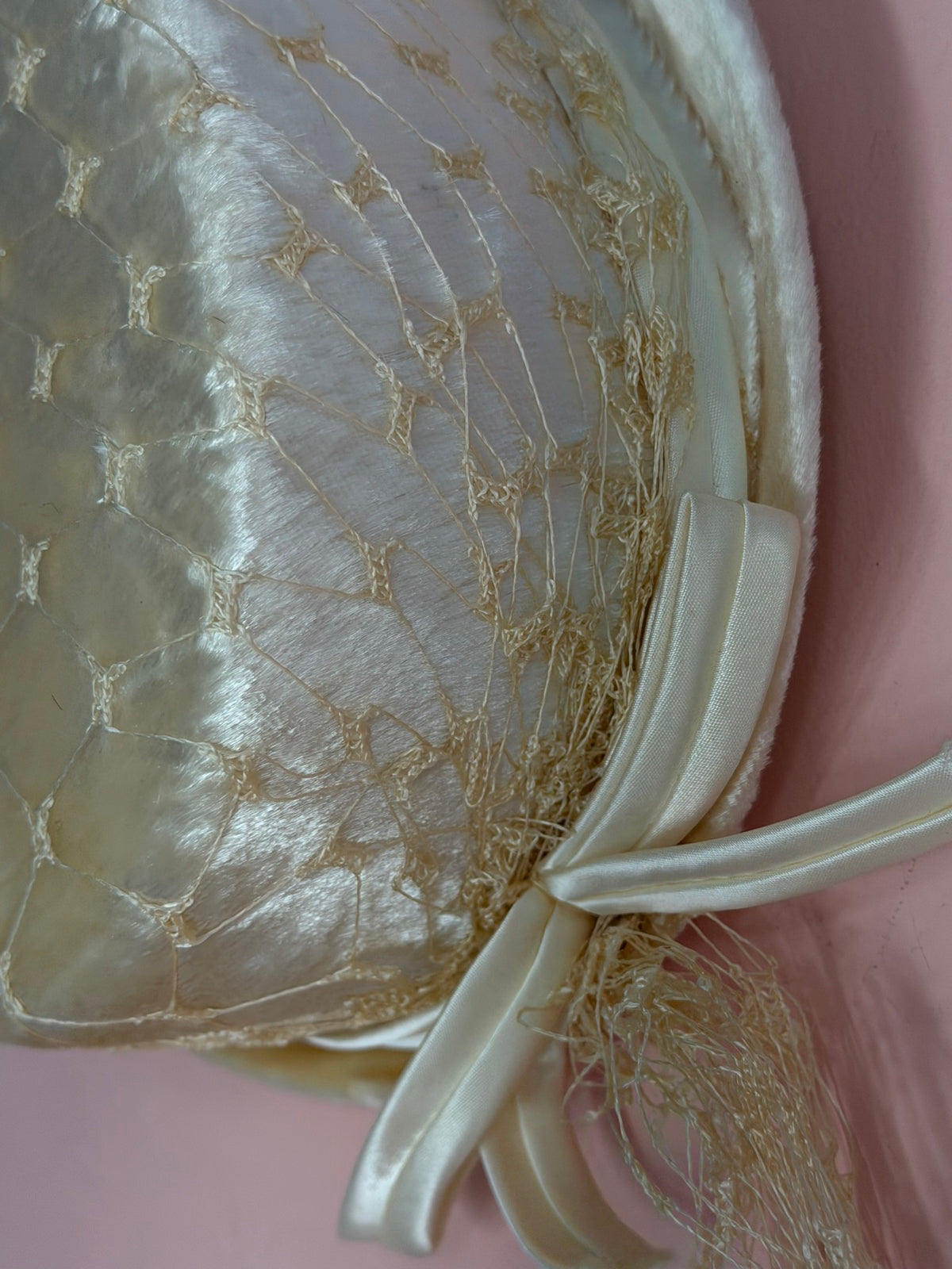 Close-up of the net overlay and satin bow on Miss Crosby's vintage ivory hat