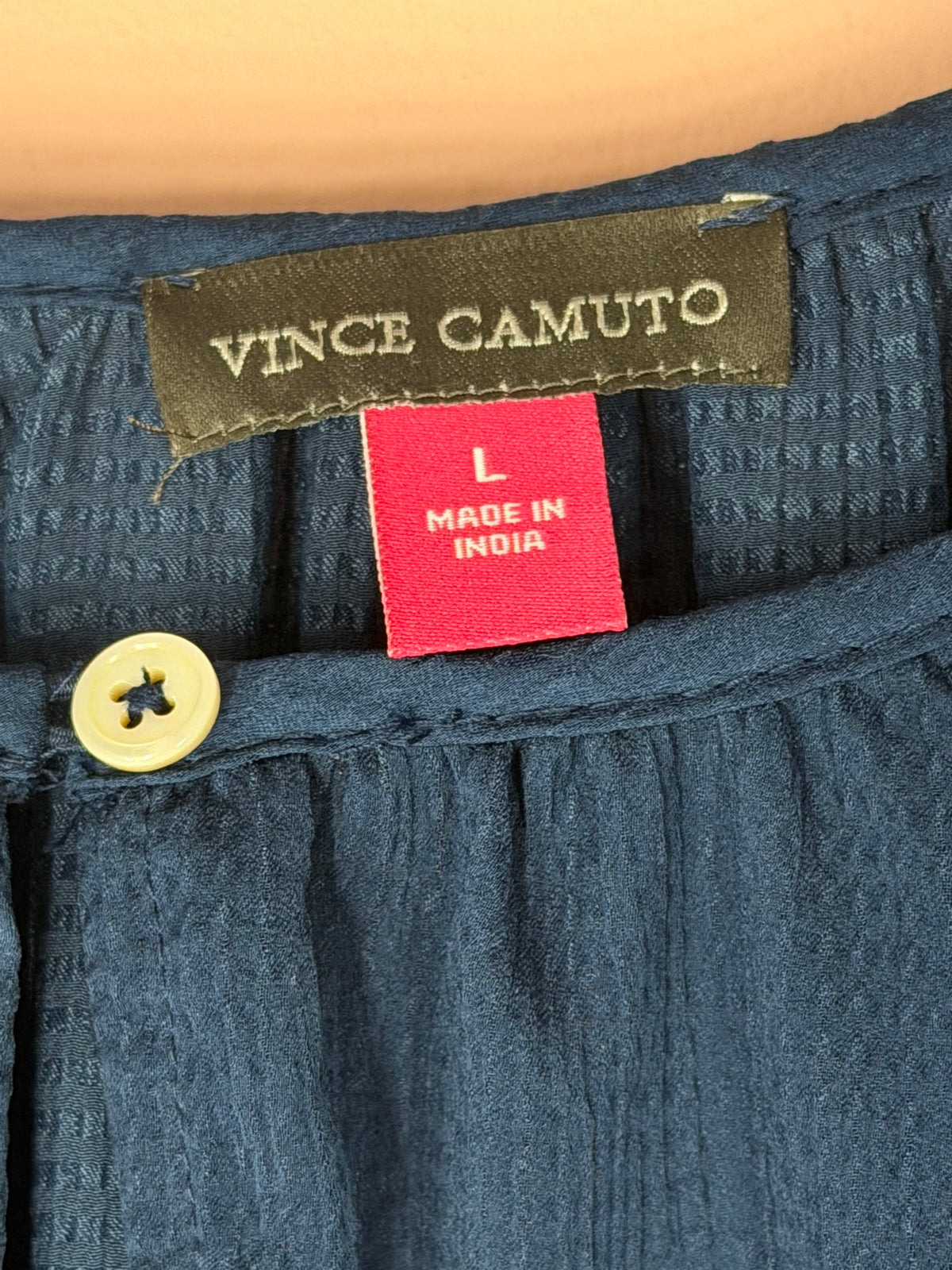 Vince Camuto brand label and size L tag inside the teal crinkle blouse