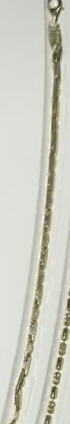 Barrel link bracelet in sterling silver with 18K gold plate laid straight on a white ridged tray in the studio case