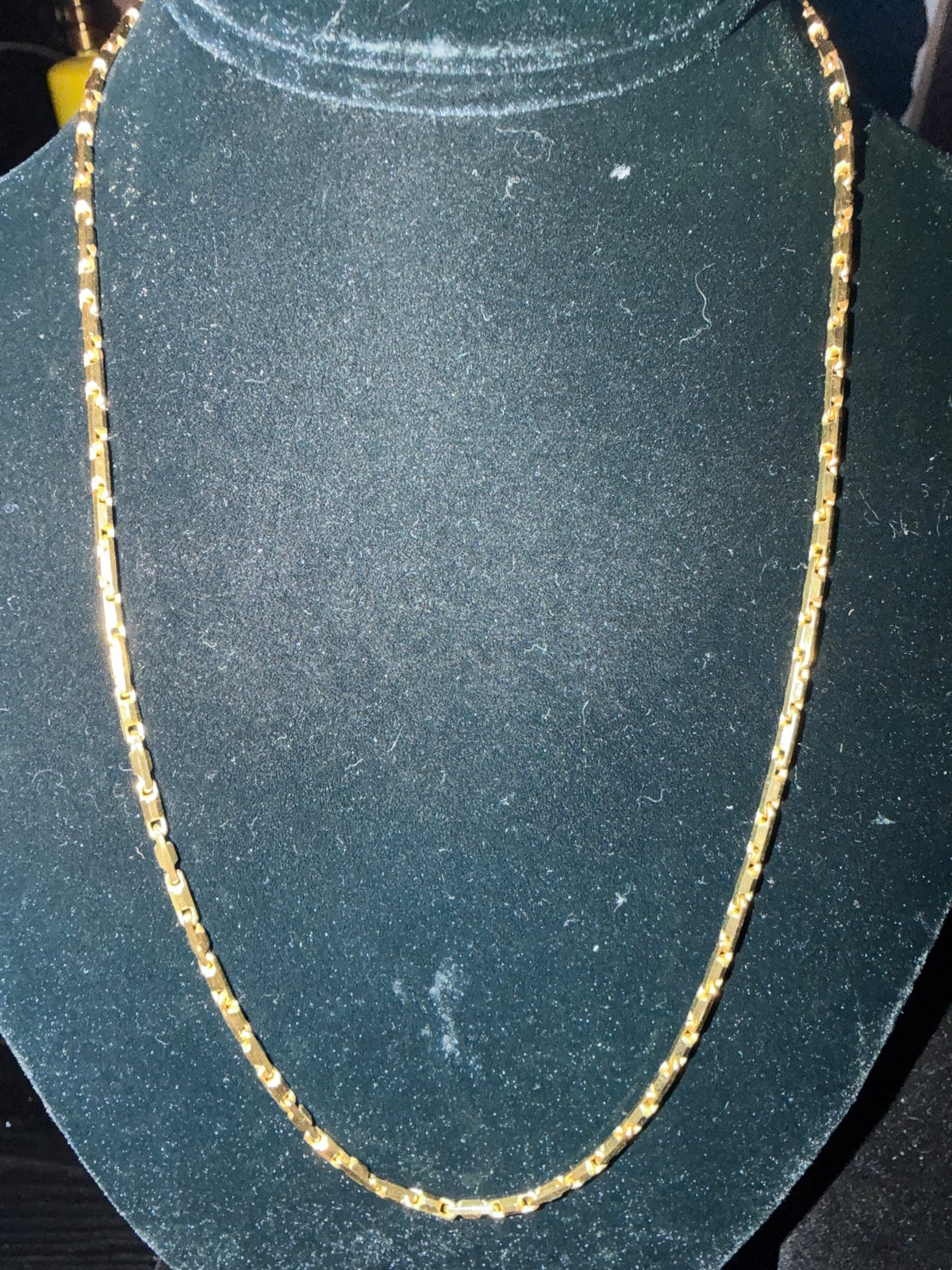 DESMOS Heshe Snap chain necklace in 18K gold plate on a black bust at Regul Silver
