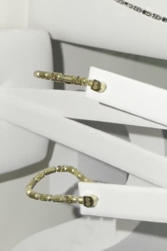 DESMOS barrel link hoop earrings in 18k gold-plated sterling silver, photographed in the DESMOS case at Regul Silver
