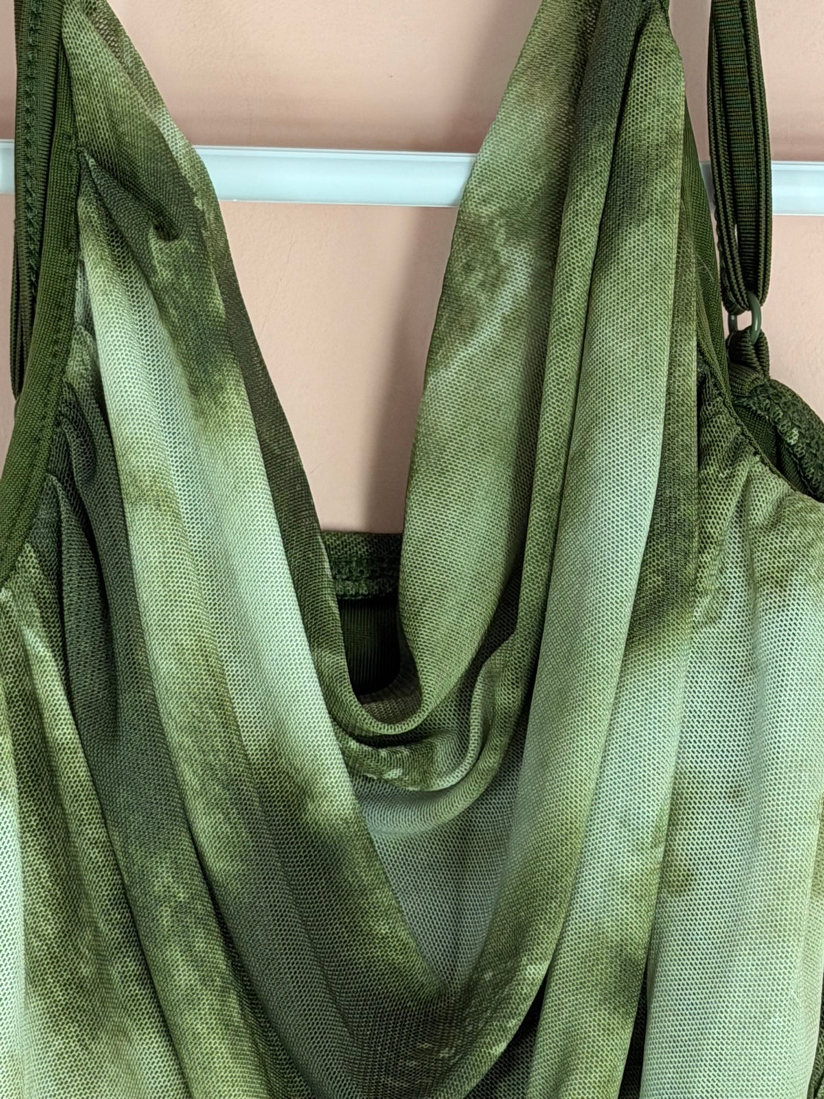 Draped cowl neckline on a green tie-dye mesh top.