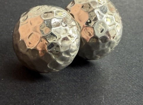 Polished hammered dome stud earrings, close-up