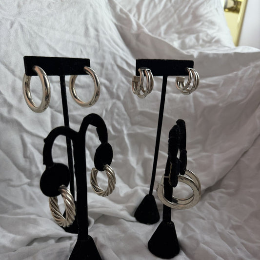 Sterling silver hoop earring wholesale variety pack showing four styles: classic hoops, triple-hoop studs, twisted rope hoops, and large thick hoops