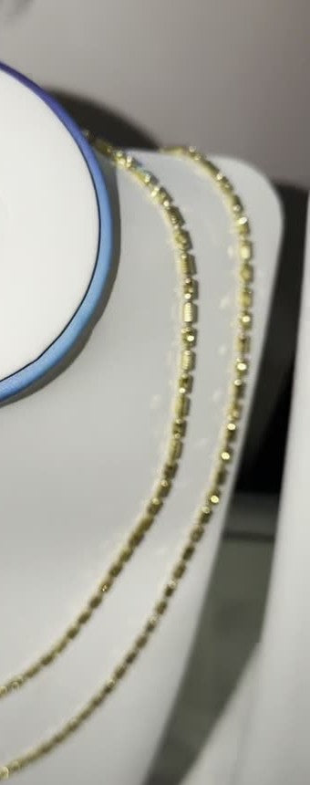 DESMOS beaded chain necklace in 18k gold-plated sterling silver, photographed in the DESMOS case at Regul Silver