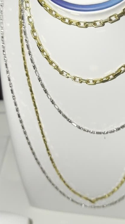 DESMOS fine link chain necklace in 18k gold-plated sterling silver, photographed in the DESMOS case at Regul Silver