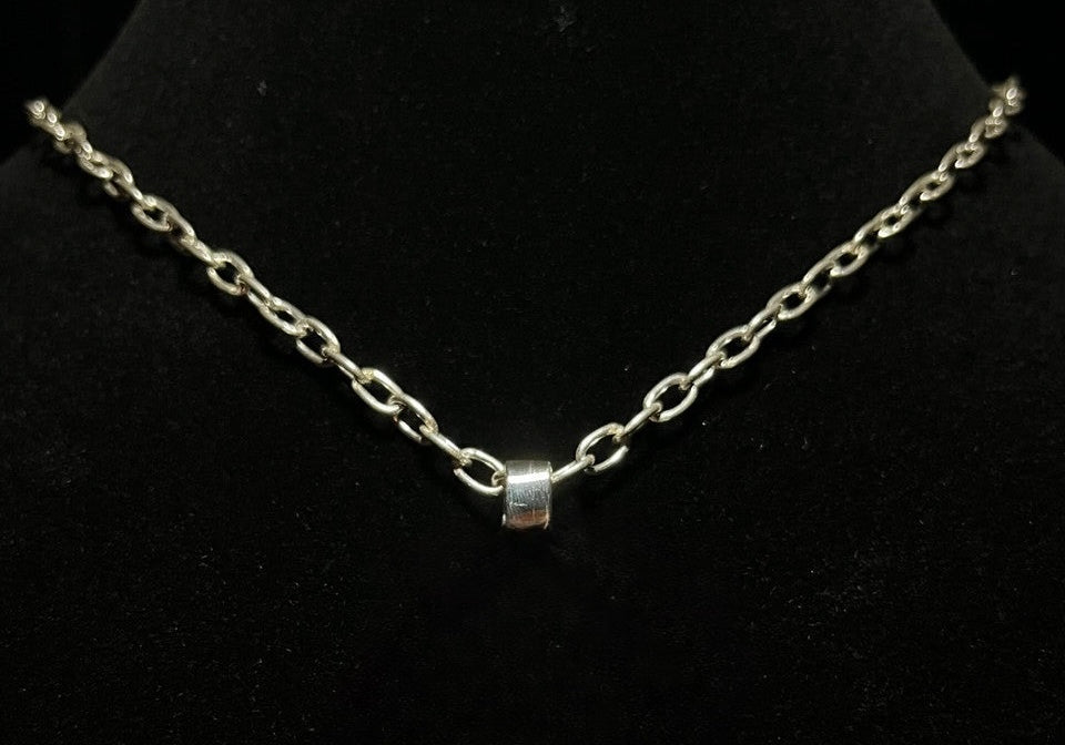 Opalite cowboy hat pendant — its rolo oval cable link chain and bail on a black bust, pendant out of frame
