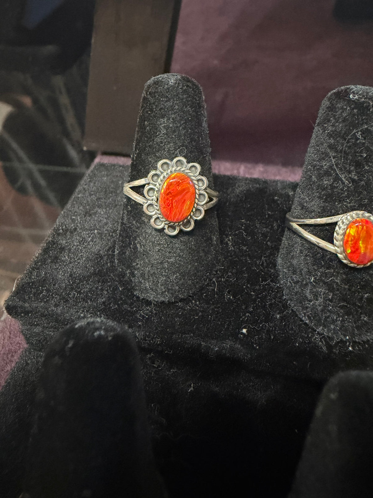 Opalite ring — orange oval handmade opalite in a scallop bezel on a ring stand, second orange ring beside