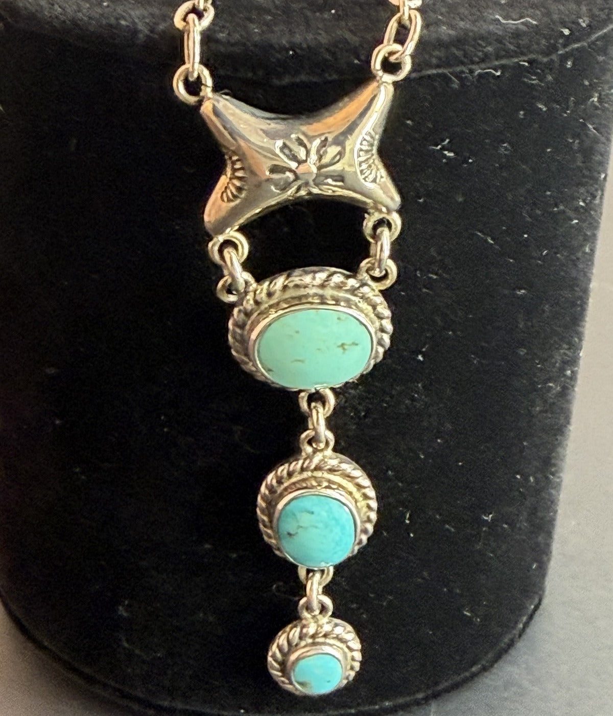 Sterling silver star necklace with three graduated turquoise stones in rope-textured bezels