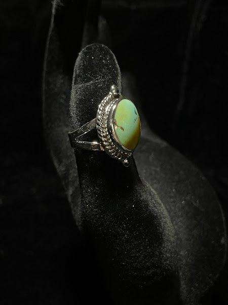 Turquoise ring — side view on black velvet showing the split shank band rising to the oval stone in its bezel surround