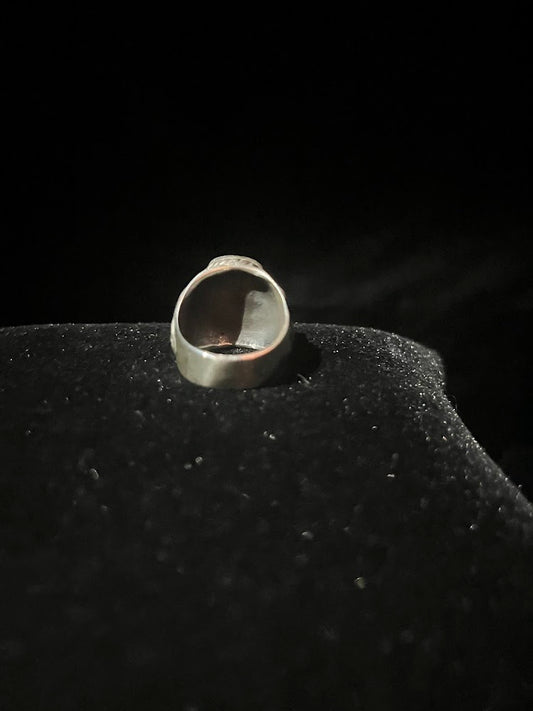 Turquoise ring — back view of the wide sterling silver band, smooth inside the shank, standing on black velvet