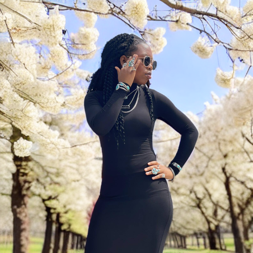 Turquoise ring — worn outdoors in a full turquoise jewelry look under white blossom trees, lifestyle view