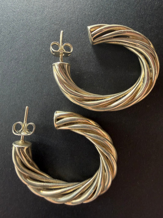 Close-up of twisted rope sterling silver hoop earrings showing rope detail