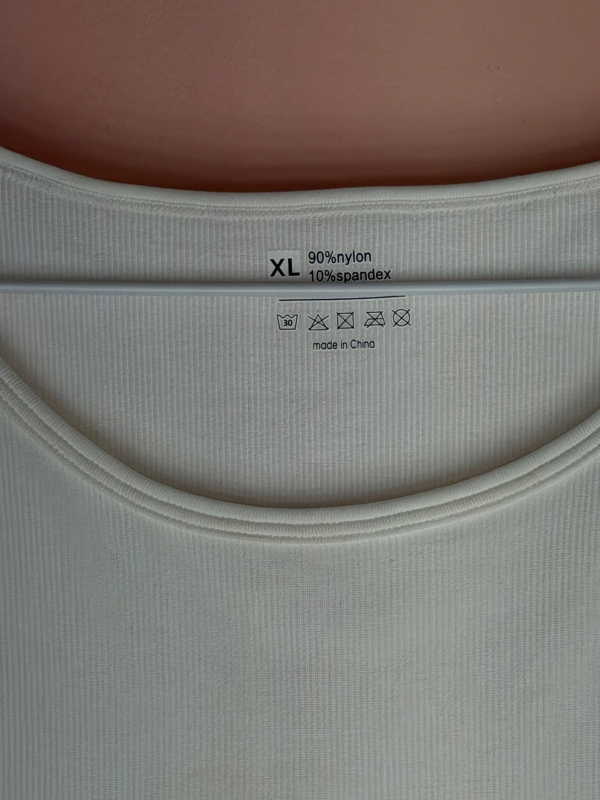 Tag showing size XL, 90 percent nylon and 10 percent spandex