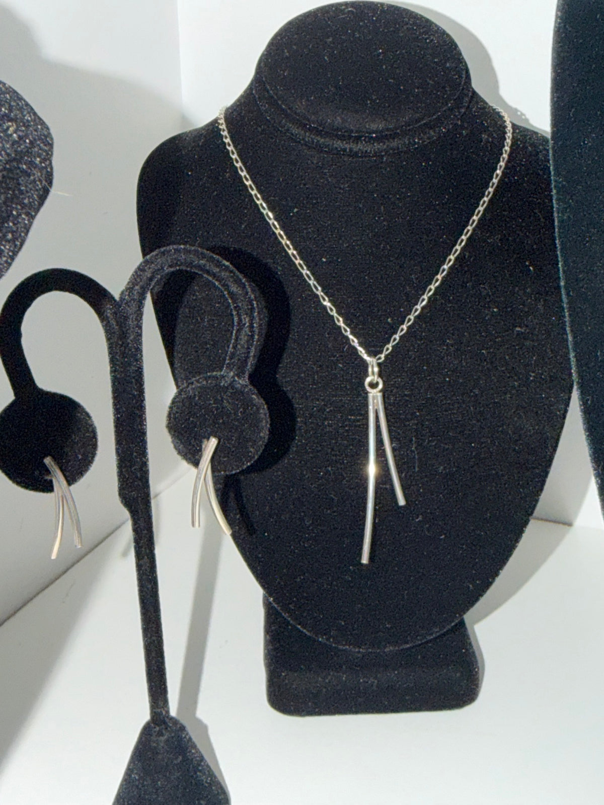 Sterling silver double-bar necklace and matching earrings set on display — Regul Silver