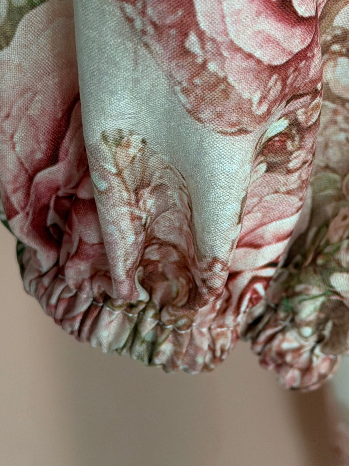 Cream rose print scoop-neck blouse, shoulder and neckline close-up