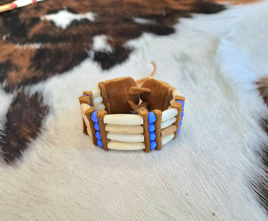 White bone hairpipe bracelet with blue beads and dark brown leather by Southwest by Design on cowhide