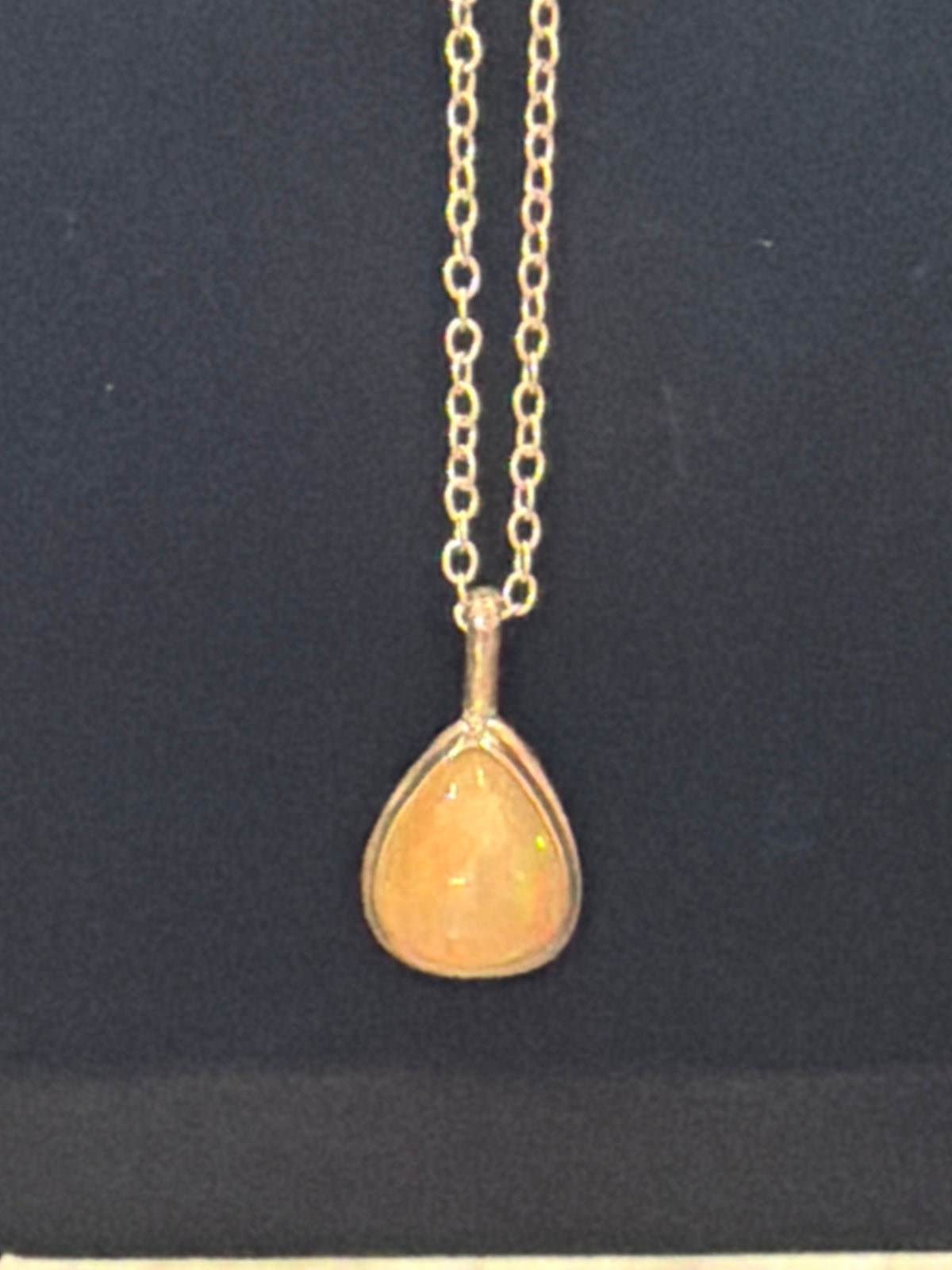 DM9 Ethiopian opal honey teardrop pendant necklace by Future World Jeweler on a sterling chain against black
