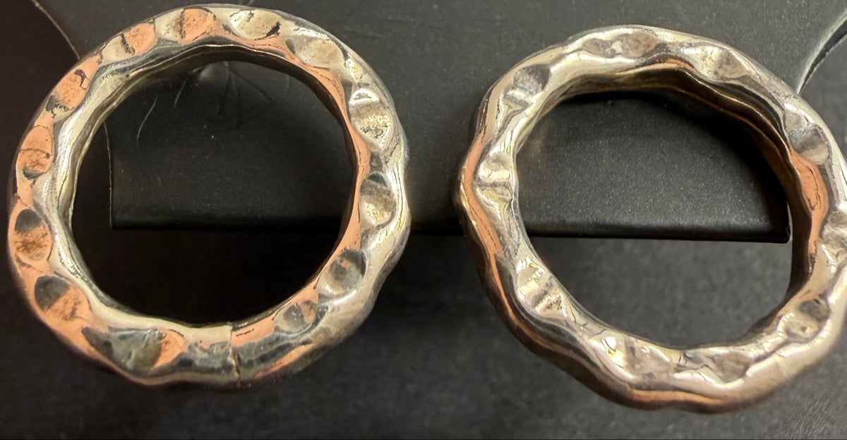 Hammered sterling silver open circle stud earrings on a black Regul Silver display card