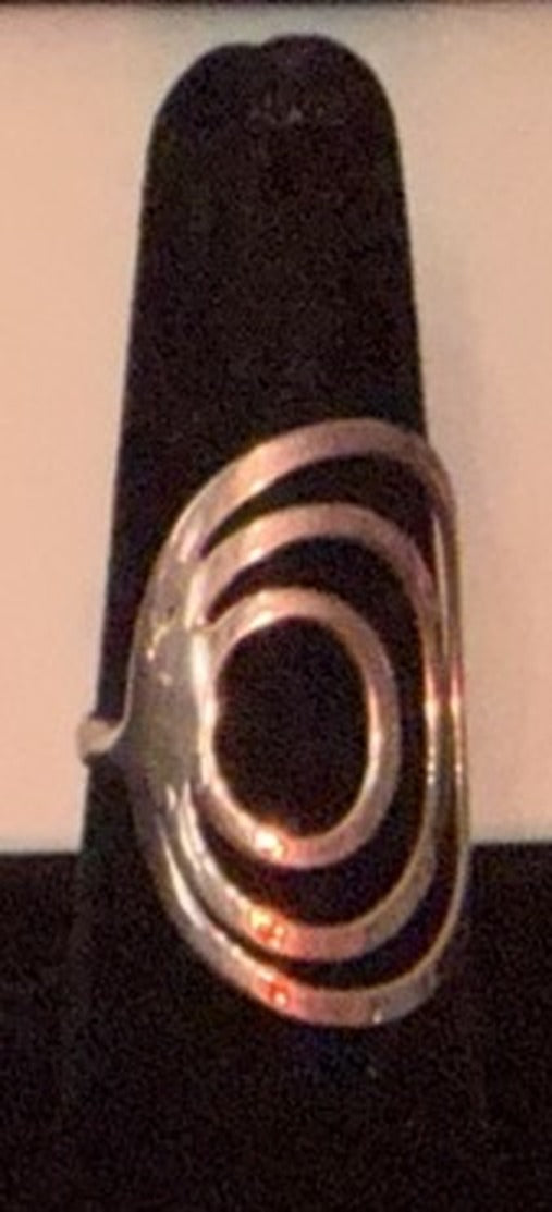 Sterling silver concentric oval spiral ring with layered oval bands on a black display cone, size 7