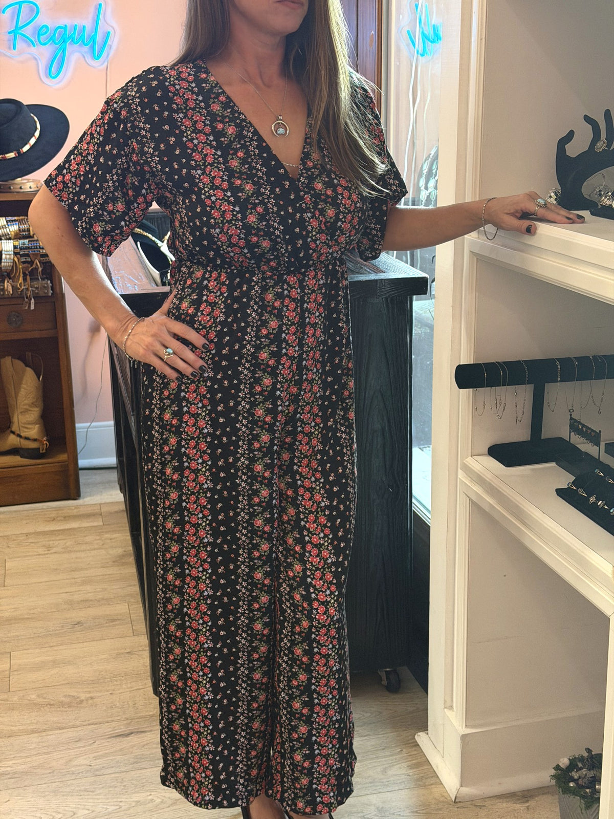 Black ditsy floral wrap wide-leg jumpsuit worn in store at Regul Design Studio
