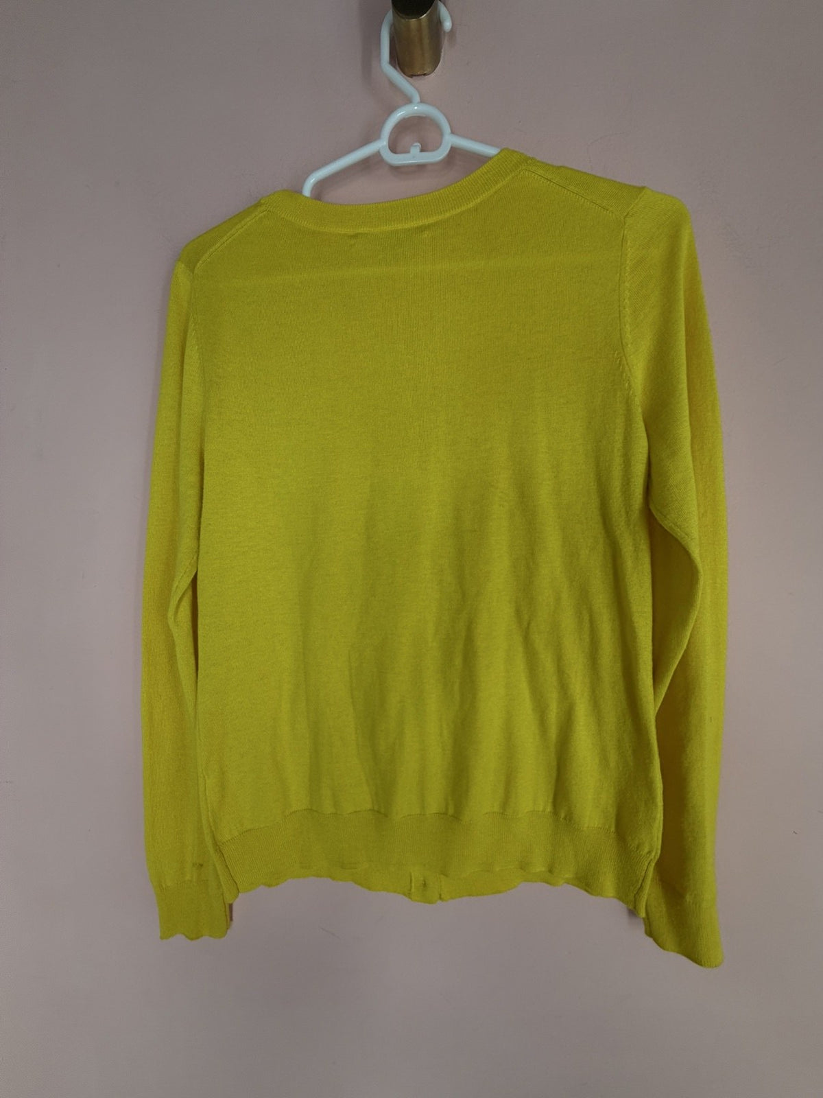 Banana Republic chartreuse polka-dot cardigan, back view on hanger