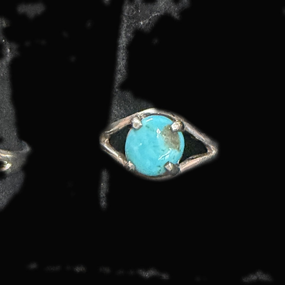 Genuine Turquoise Oval Solitaire Ring — bright sky-blue oval with a brownish-green patch to one side