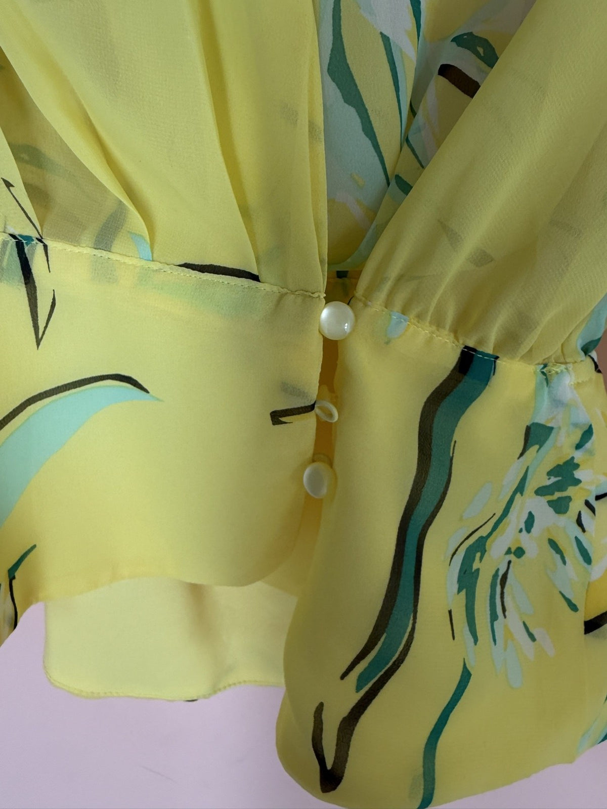 Eva Mendes yellow floral wrap blouse, wrap and pearl-button detail