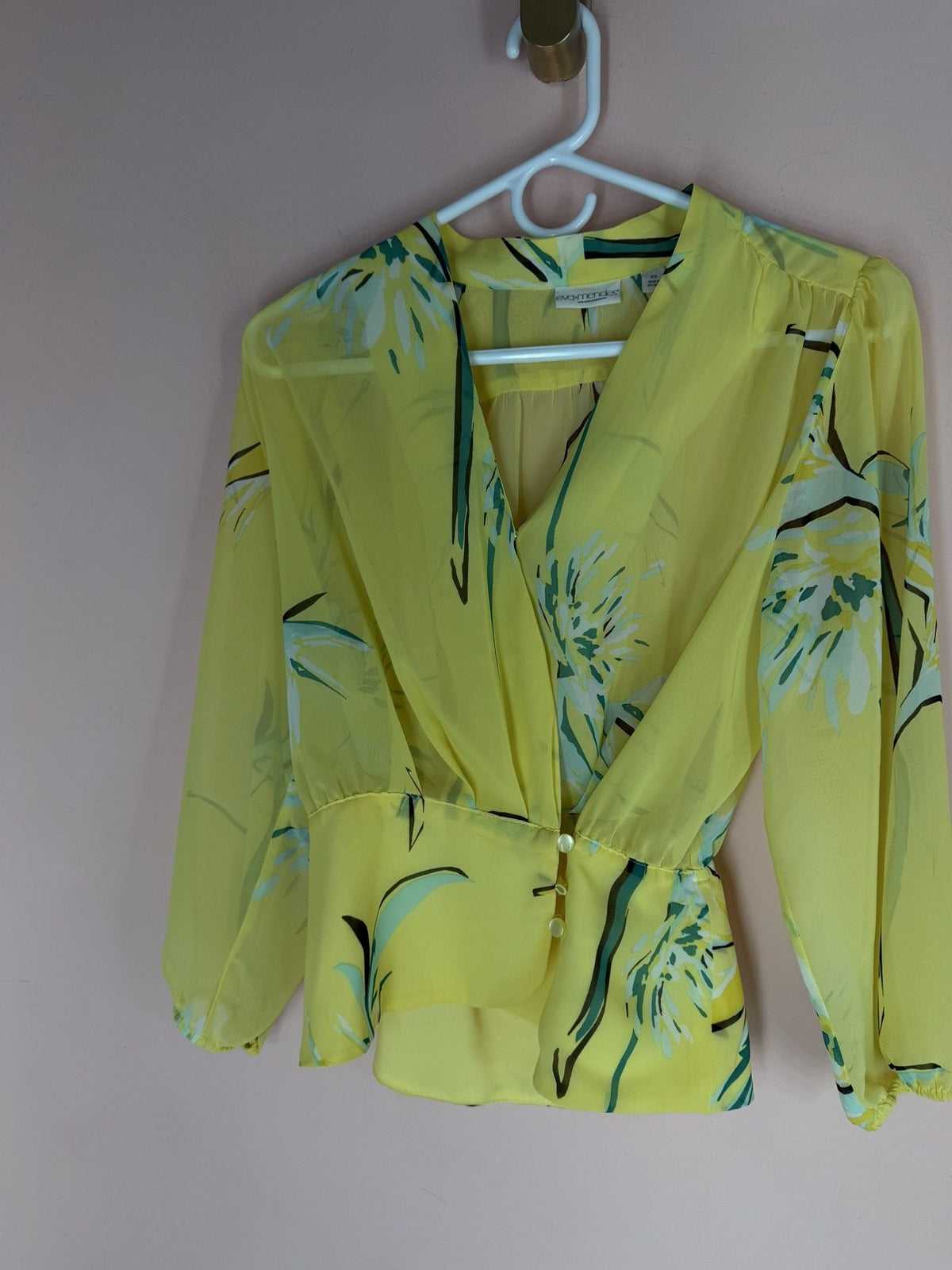 Eva Mendes yellow floral wrap blouse, full view on hanger