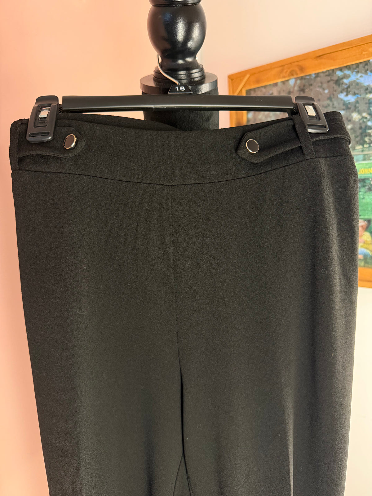 NYCC black pants waist close-up showing the button tab detail