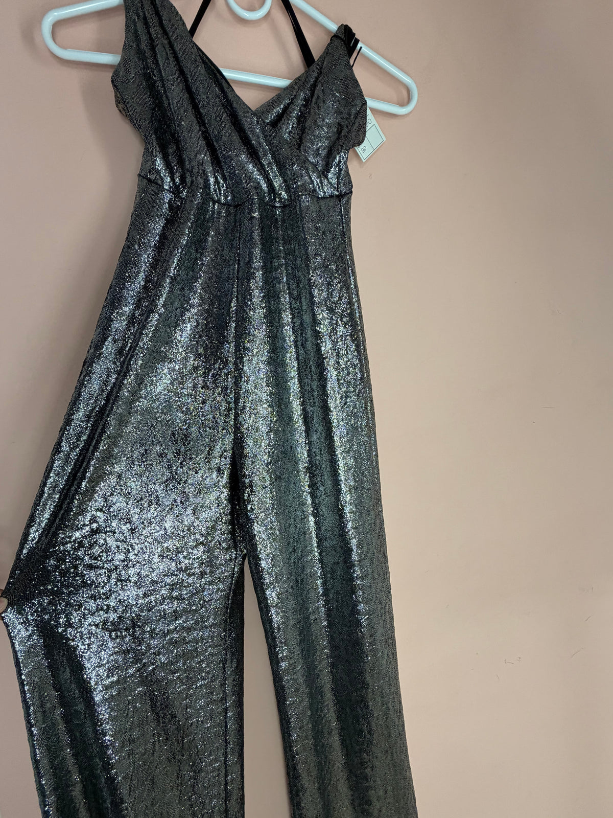 Silver metallic sleeveless jumpsuit, front view showing wide legs