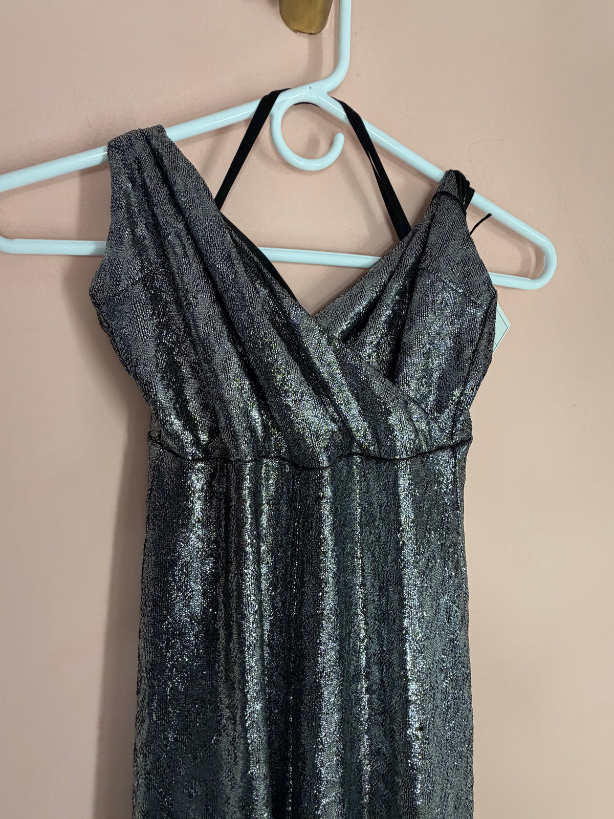 Silver metallic jumpsuit, close-up of draped crossover bodice