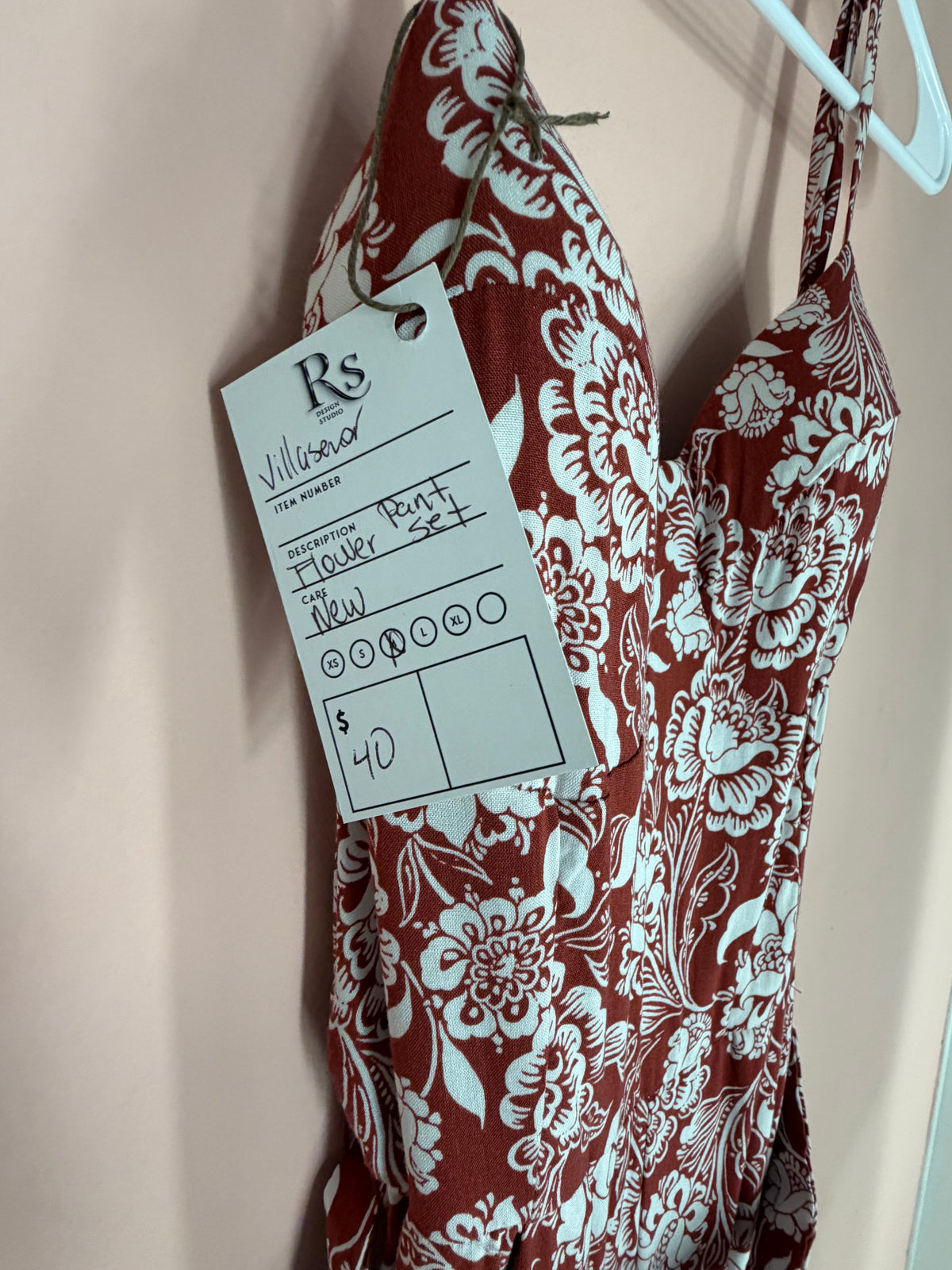 Rust and white floral jumpsuit Regul Design Studio price tag close-up, size M