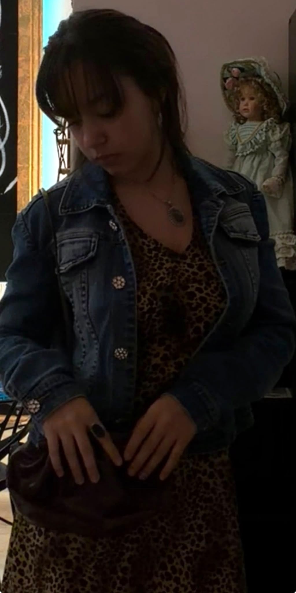 Leopard print V-neck dress worn under a denim trucker jacket in store at Regul Design Studio