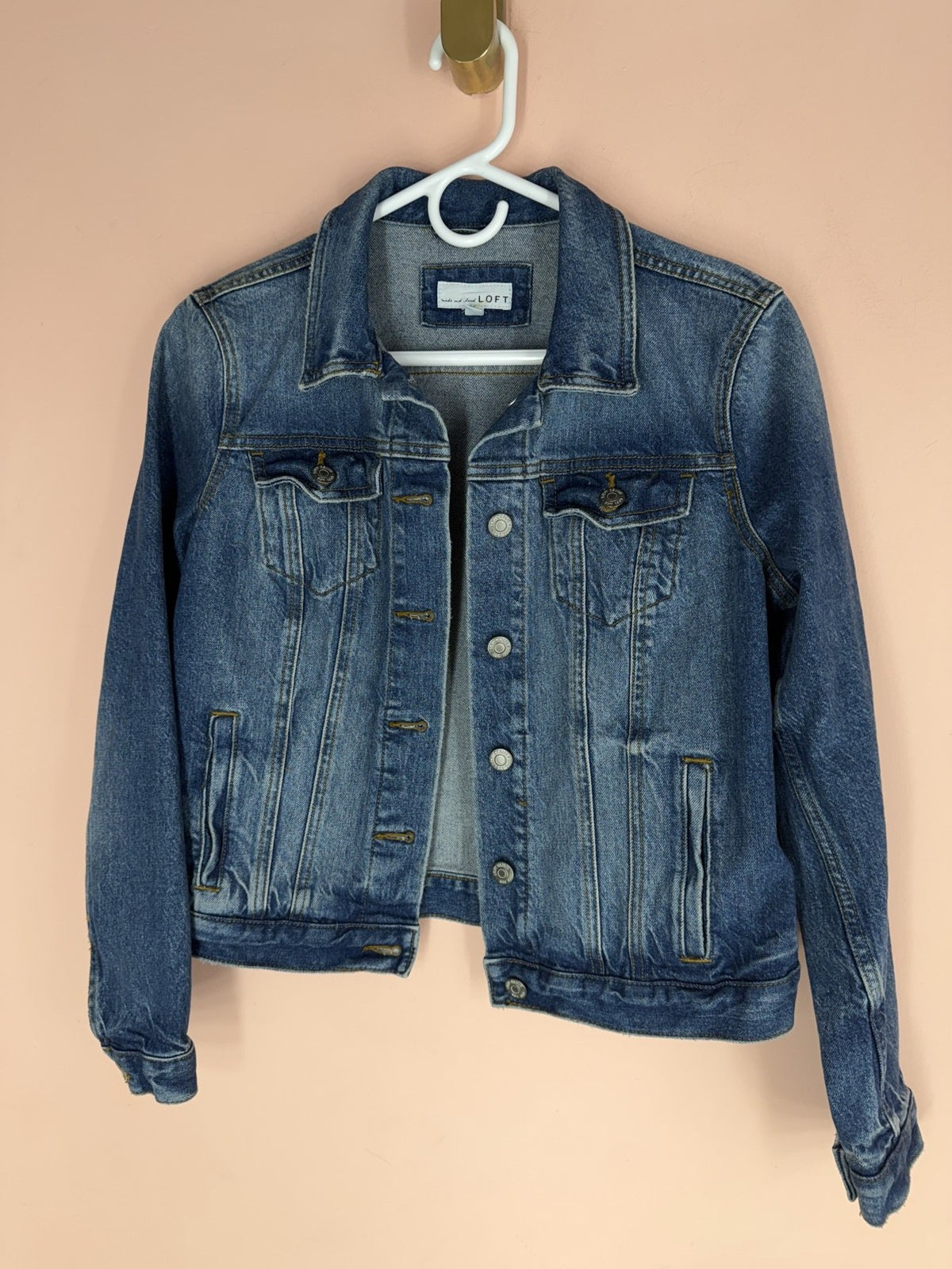 LOFT denim trucker jacket, front view on hanger