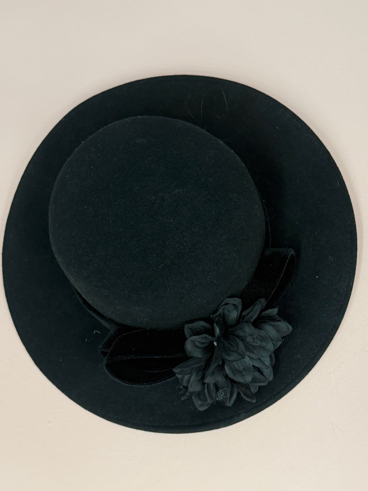 Miss Crosby's vintage black felt hat with velvet bow and black silk flower, top view