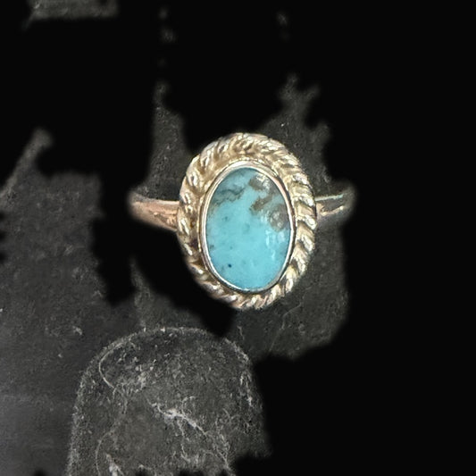 Genuine Turquoise Oval Ring — clean medium-blue oval with a single golden-brown patch kissing one corner