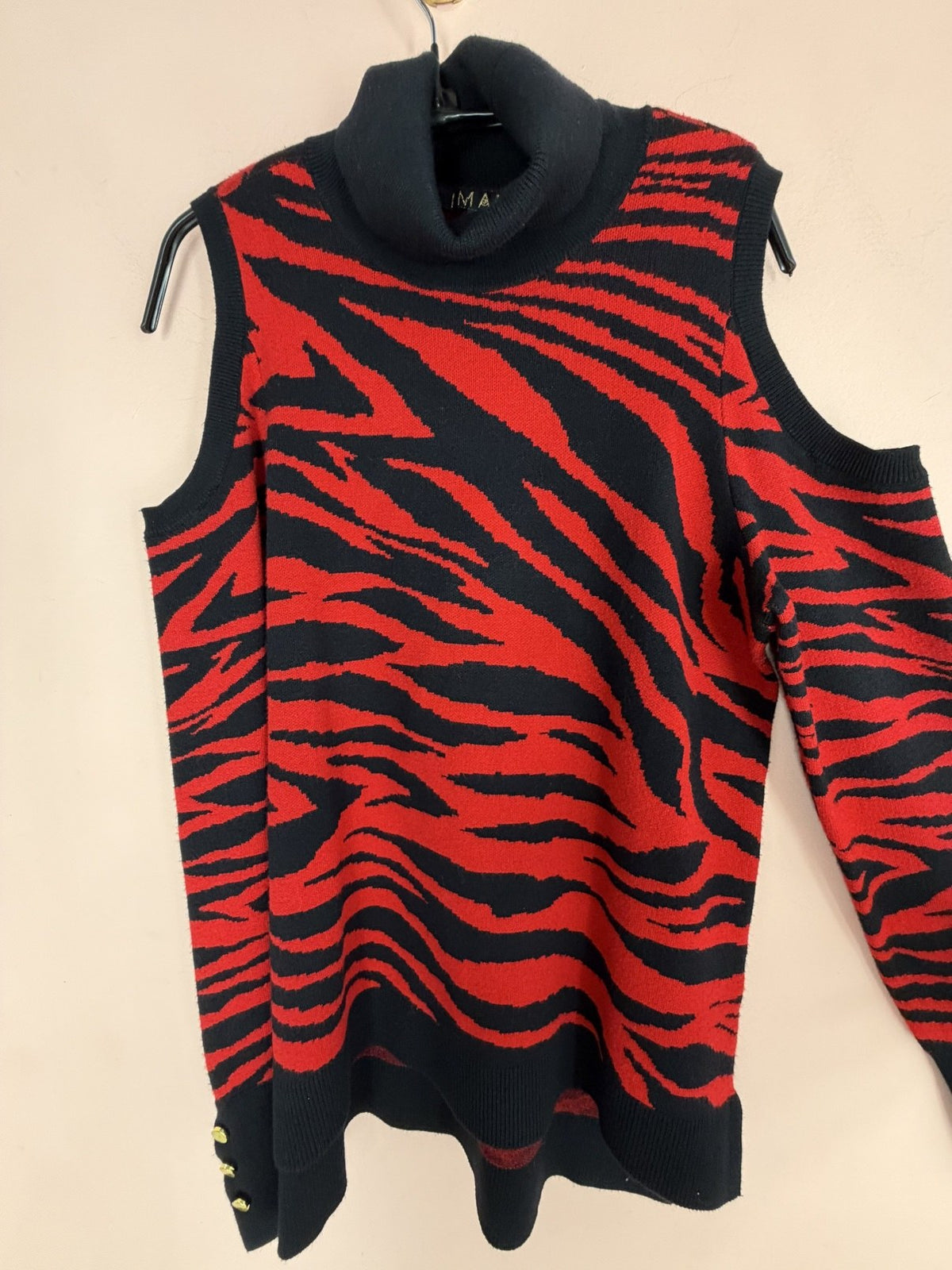 Red and black zebra cold-shoulder sweater, full view on hanger