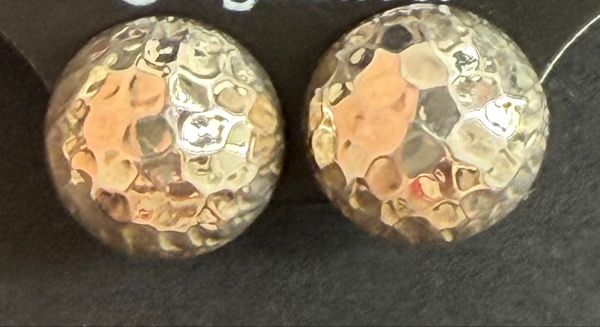 Hammered dome sterling silver stud earrings on a black Regul Silver display card