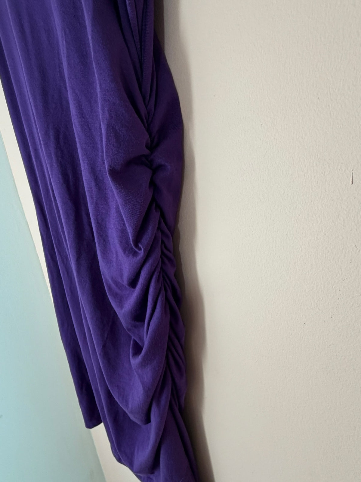 Side ruching detail close-up of purple tank dress