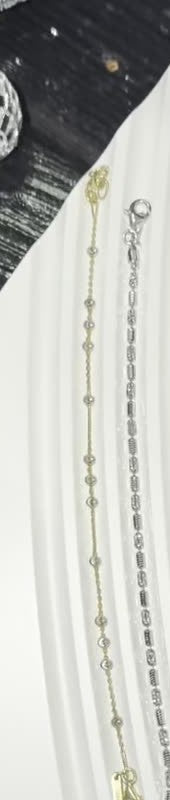 DESMOS beaded station bracelet in 18k gold-plated sterling silver, photographed in the DESMOS case at Regul Silver
