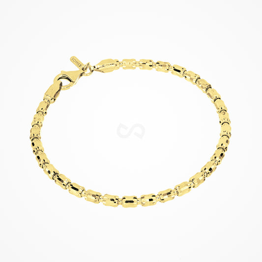 Barrel link bracelet in sterling silver with 18K gold plate in a full oval on white, faceted barrels, clasp and tag at top