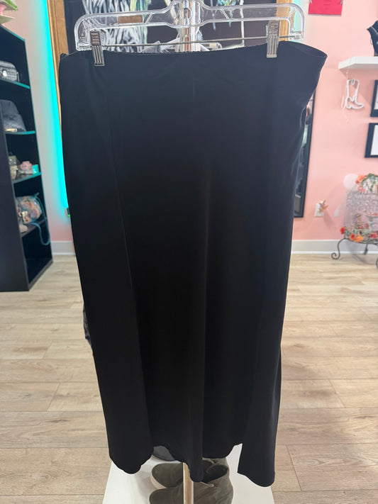 Front view of a like new black A-line column maxi skirt hanging on a boutique rack.