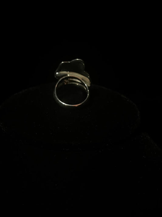 Cowboy hat ring — back view showing the split shank band and the smooth back of the silver face on black