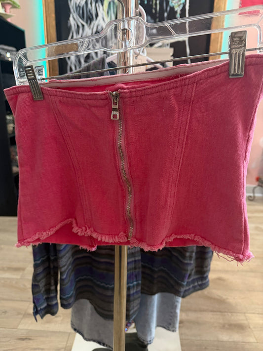 Front view of a like-new Superdown pink strapless denim corset top hanging on a rack, featuring a silver center zipper and frayed hem.