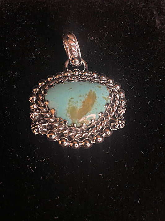 Genuine turquoise pendant - front view of the pale blue-green oval stone with its gold matrix heart in scalloped silver