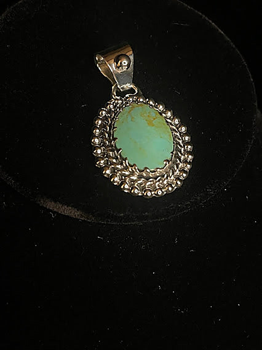 Genuine turquoise pendant - front view of the pale green oval Tyrone stone in its scalloped sterling silver bezel